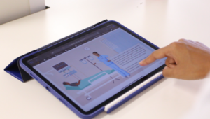 A tablet showing an animation of a doctor and patient.
