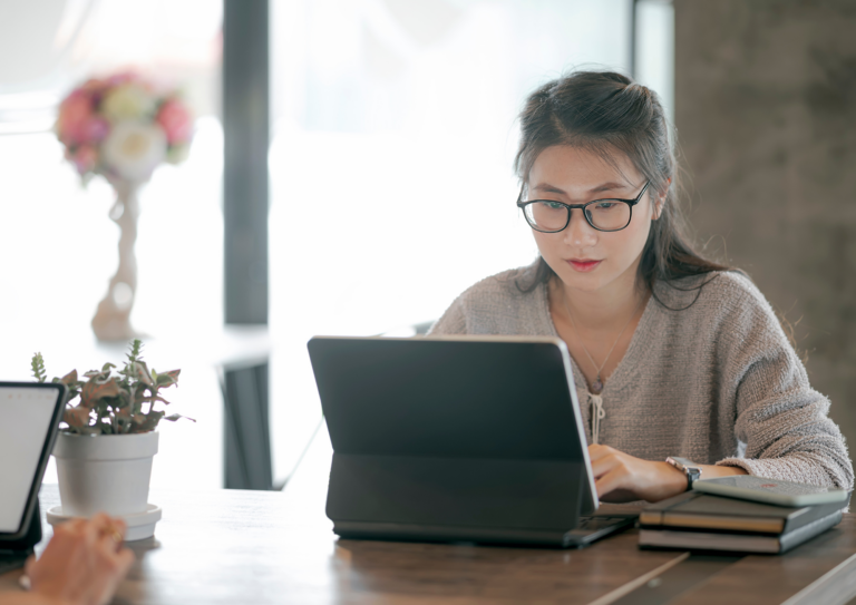 Young woman at computer in cafe