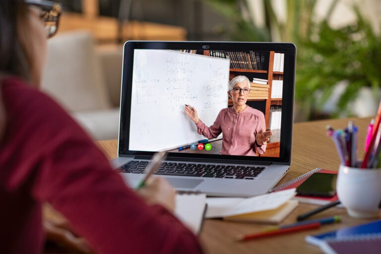 A student watches a video of an academic giving a lecture