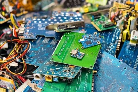 A pile of discarded computer chips and hard drives.